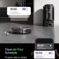 Robotic vacuum cleaner on a kitchen floor with smartphone app interface showing cleaning schedule.
